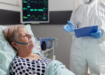 Estetoscópio e máscara cirúrgica ao lado de um termómetro, simbolizando prevenção da gripe H3N2 subtipo K